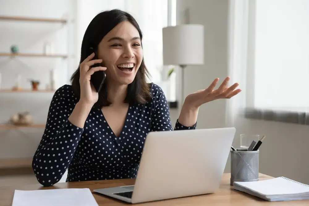 Someone on the phone, happily in a call and in talks for a collaboration with a food influencer.