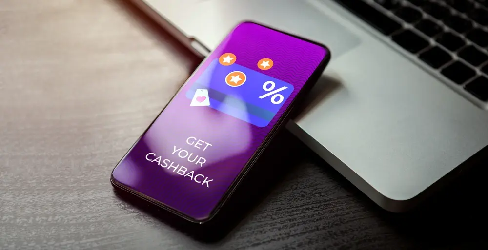 A phone showing cash back mechanics for higher-tier members of a loyalty program.