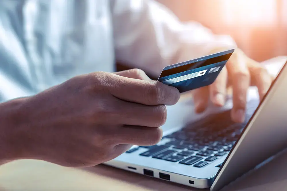 Shows a customer using a credit card, highlighting the need for eCommerce to have multiple payment options.