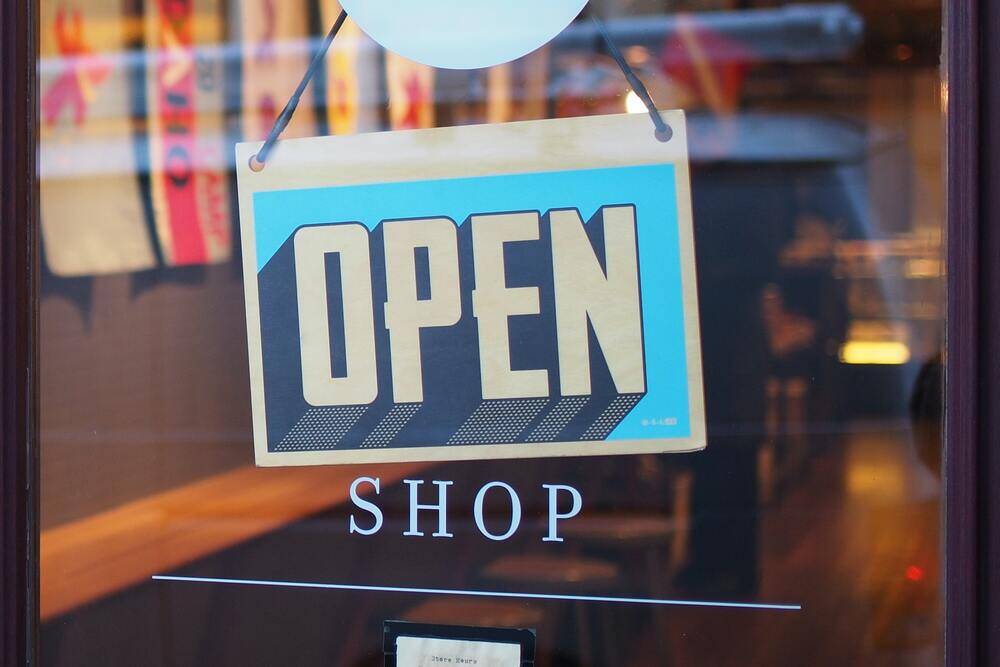 A retail storefront with an open signage, showing that the business is ready for operations.