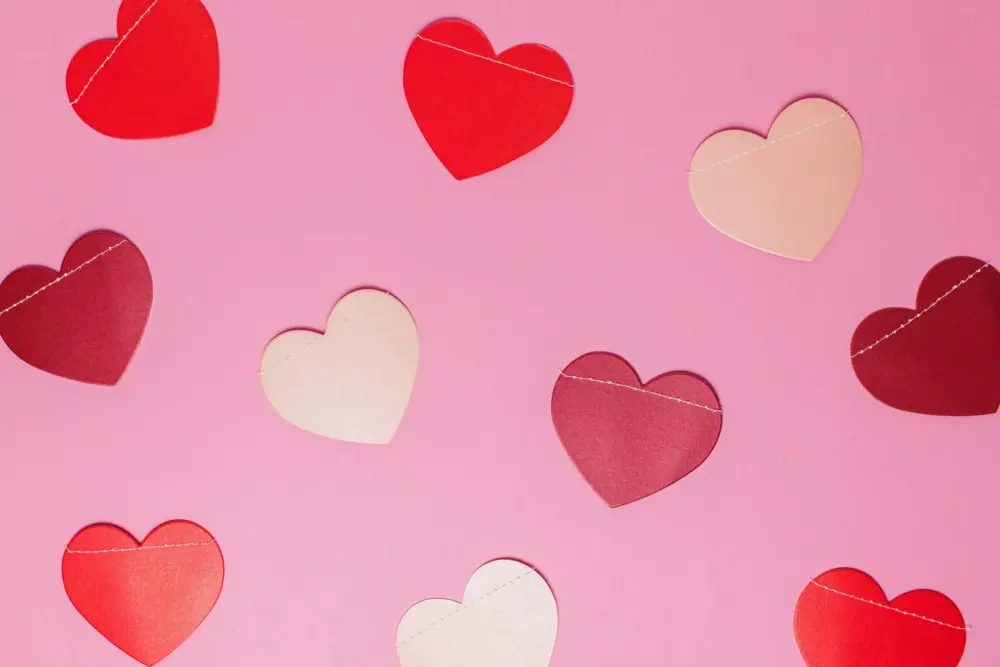 Paper heart cut-outs, which are popular trends and elements for Valentine's Day campaigns.