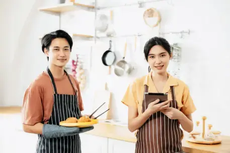 Is the banner for the Demo section on the RUSH eStore Pricing page, which shows a woman and man in a kitchen, smiling as they're using programs that provide rewards for their customers.