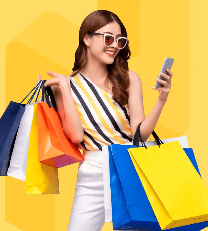 Is the main image for RUSH's Loyalty Program pricing and included features, but features a woman holding shopping bags and enjoying her rewards program.