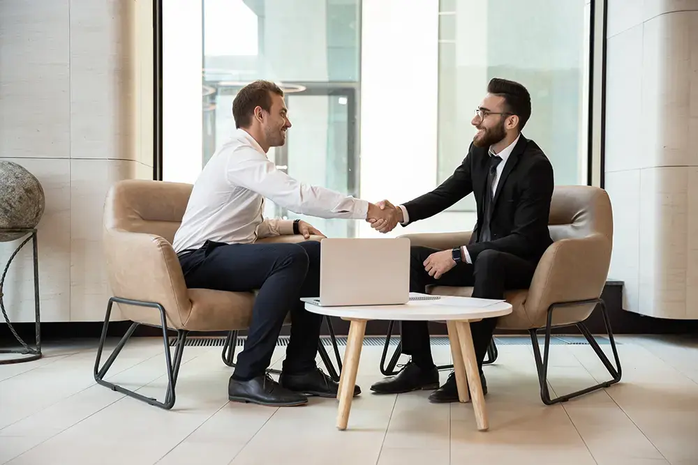 Shows a business rep and customer shaking hands, emphasizing the value of loyalty programs in building relationships.