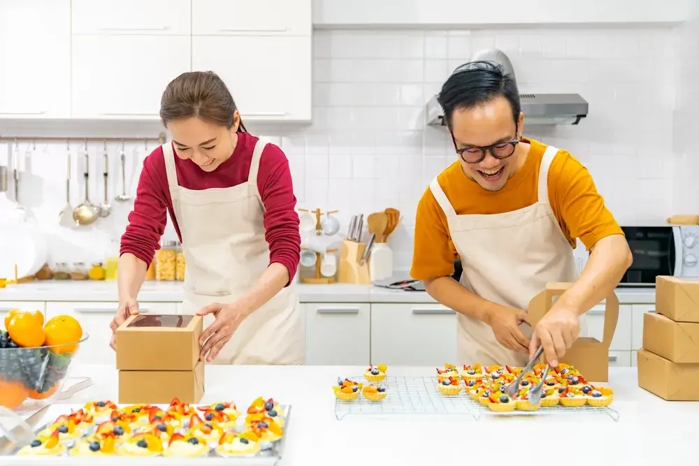 Two people packing their food products in bundles for cross-selling and upselling on their eCommerce platform.