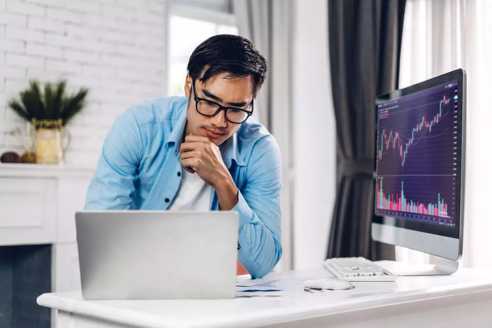 A business owner uses his laptop to analyze eCommerce trends in the Philippines.