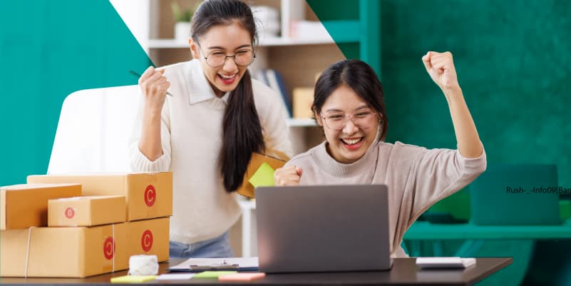 Shows two business owners cheering as they see their eCommerce sales increase.