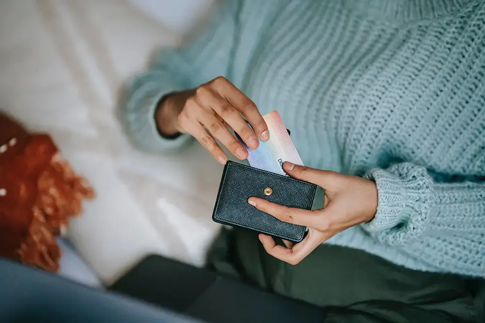 Shows a customer bringing out a credit card, a preferred online payment method for eCommerce platforms.